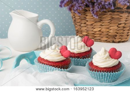 Red velvet heart cupcakes with cream cheese frosting and a red heart for Valentine's Day