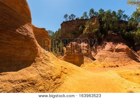 Orange ochre picturesque hills. Luberon, Roussillon Provence France. Preserve natural dye production - ocher.