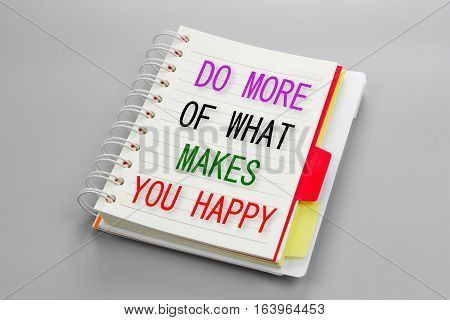 Text Do more of what makes you happy on white notebook paper