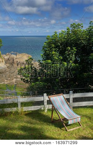 Chaise lounge on the green lawn. Excellent View of the Bay of Combe Martin. North Devon. UK