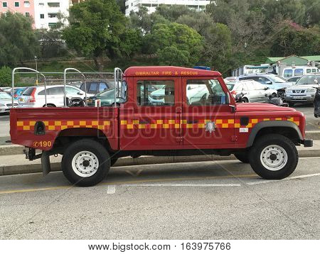 Gibraltar, Gibraltar - December 29, 2016: Red Gibraltar Fire Brigade Land Rover Defender parked on a public parking spot in the city of Gibraltar. Nobody in the vehicle.