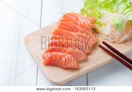 salmon sashimi on wood block and white wood background Japaness food concept healthy food and diet