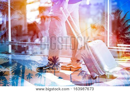 Double exposure man pulling suitcase in the airport to travel with coconut tree in island