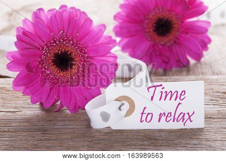 Label With English Text Time To Relax. Pink Spring Gerbera Blossom. Vintage, Rutic Or Aged Wooden Background. Card For Spring Greetings.