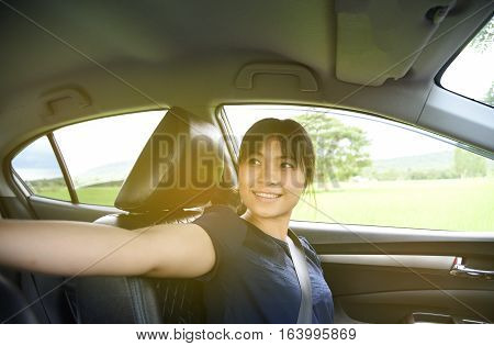 Woman taking a photo with smart phone in car with sunlight,Woman selfie in car