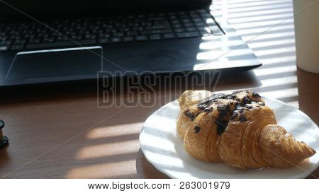 A Businessmans Desk With A Disposable Cup For Coffee And Fast Food. Open Laptop Computer. Breakfast 