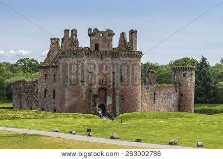 Shearington, Scotland, Uk - June 18, 2012: Closeup Of Ruined  Triangular Brown Stone Moated Caerlava