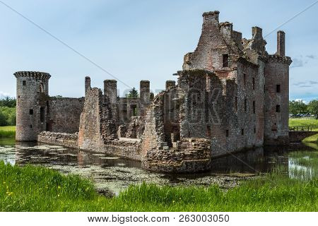 Shearington, Scotland, Uk - June 18, 2012: South And East Side Of Ruined  Triangular Brown Stone Moa