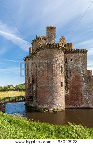 Shearington, Scotland, Uk - June 18, 2012: Entrance Tower And Bridge Over Moat Or Ruined  Brown Ston