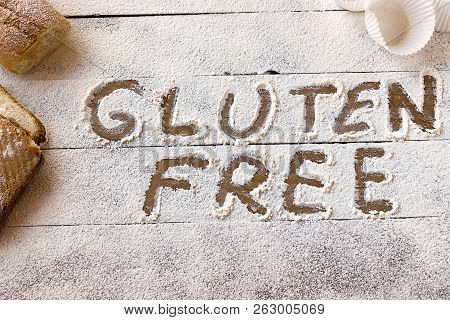 Gluten Free Concept. Wooden Table With Flour And Pastry Material, With The Written Phrase Gluten Fre