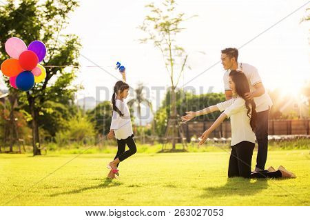 Asian Family Run And Play In A Garden, This Immage Can Use For Father, Mother, Kid And Summer Concep