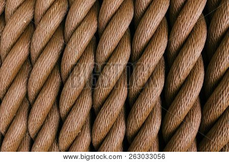 Thick Brown Rope Rolled Into A Roll. Vertical Layout. Background Texture