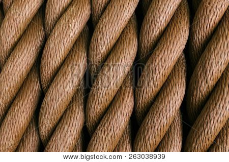 Thick Brown Rope Rolled Into A Roll. Vertical Layout. Background Texture