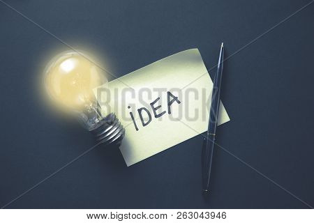 Lidea With Ight Bulb On The Table