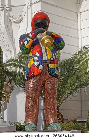 Nice, France - January 20, 2012: Statue Of Musician Playing Trumpet In Front Of Le Negresco Hotel In