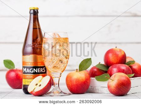 London, Uk - September 13, 2018: Bottle And Glass Of Magners Original Cider With Fresh Apples On Woo