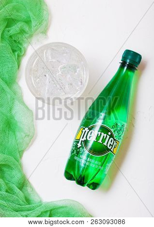 London, Uk - October 10, 2018 : Bottle Of Perrier Sparkling Water With Glass And Green Cloth. Perrie
