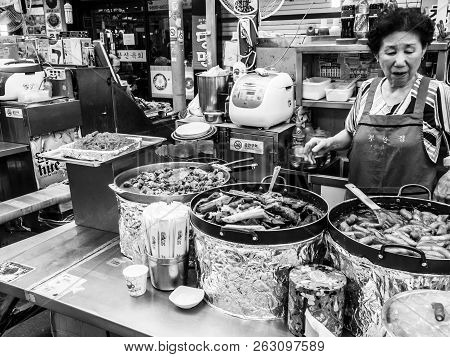 Seoul, South Korea - June 21, 2017: Woman Vendor Serving Customers At Gwangjang Market In Seoul.