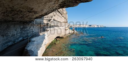 Panoramic View Looking Out From A Coastal Path Cut Into The Side Of A White Limestone Chalk Cliff Wh