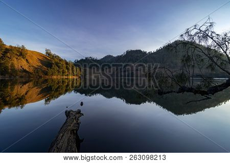 Beautiful Nature Landscape By The Lakeside Will Full Reflection In The Morning.ranu Kumbolo Lake, Se