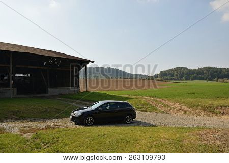 Destna, Czech Republic - September 28, 2018: Black Car Opel Astra, Stock Building And Nature Of Mach