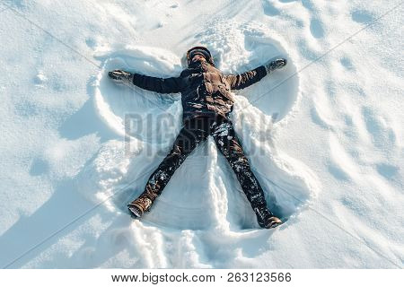 The Boy On A Snow Flapping Arms And Legs Angel Shows.