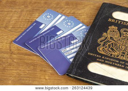 Old Black British Passport With European Health Insurance Cards