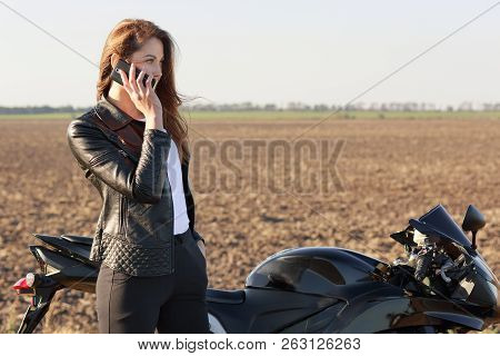 Female Biker Has Phone Conversation, Stops On Road, Poses Near Motorbike, Dicusses Latest News With 