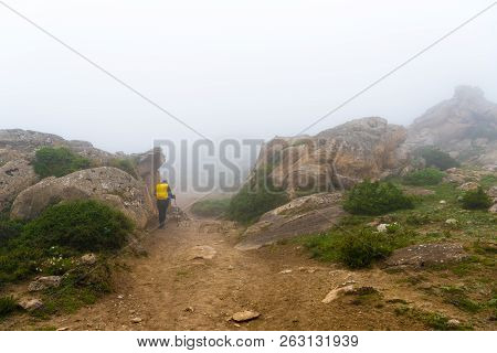 Backpackers On Foggy Trekking Path In Annapurna Conservation Area, Nepal