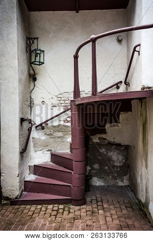 Chipped Plaster Walls And An Old Spiral Staircase In Historic Smithville Village In New Jersey.
