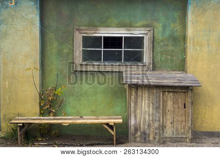 The Window In The Old House. Large Booth And Bench Near The House In The Village.
