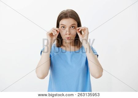 Wow, Give Me Two. Portrait Of Impressed Interested Attractive Woman In Nerdy Glasses, Touching Rim O