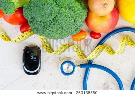 Diabetes Healthy Diet Concept, Raw Vegetables With Blood Glucose Meter And Stethoscope