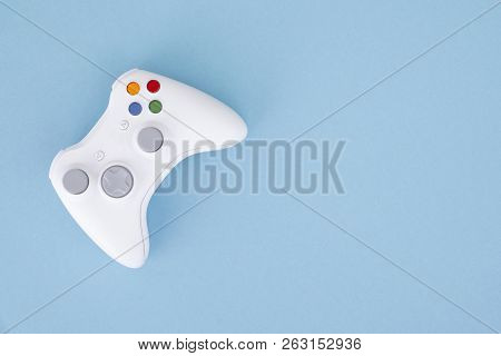 White Joystick Is Isolated On A Pastel Blue Background. Video Game. Gaming Concept. Copyspace. Flayl