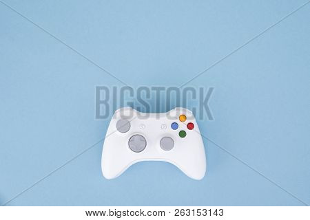 White Joystick Is Isolated On A Pastel Blue Background. Video Game. Gaming Concept. Copyspace. Flayl