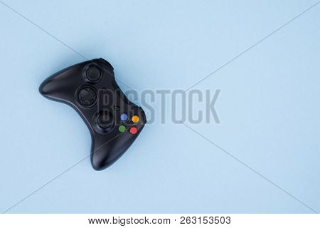 Black Joystick Is Isolated On A Pastel Blue Background. Video Game. Gaming Concept. Copyspace. Flayl