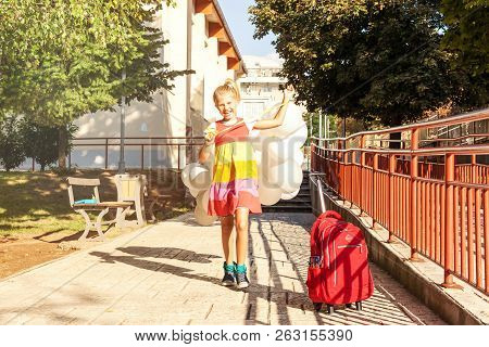 Happy Beautiful S8 Year Old Chool Girl With Balloons In The School Yard