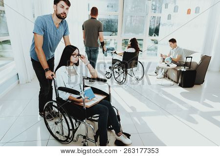 People In Wheelchair. Disabled In Hall. Woman In Wheelchair. Man On Crutches. Group Disabled People.