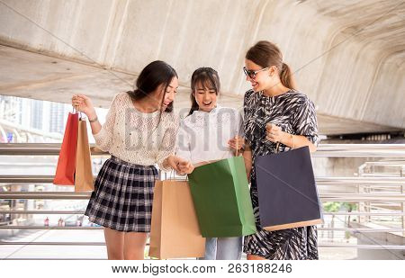 Beautiful Surprise Women Smling And Holding Shopping Bags In City Street,lifestyle Concept