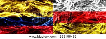 Colombia Vs South Ossetia Smoke Flags Placed Side By Side. Thick Colored Silky Smoke Flags Of Colomb