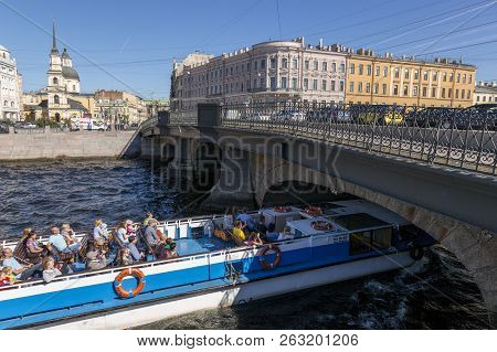 St. Petersburg, Russia - August 08, 2018: Pleasure Boat Sails Under The Belinsky Bridge On The Fonta