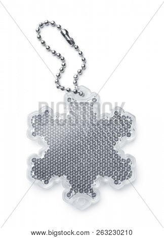 White snowflake safety reflector keyring isolated on white