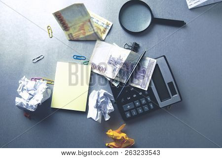 Different Stationary And Money On The Desk