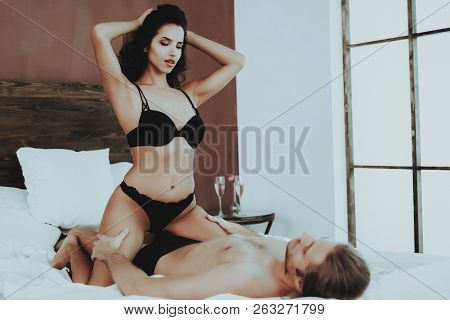 Girl Sitting On Man. Person In Black Underwear. White Linen. Man On Bed. Woman With Man. Girl In Lin