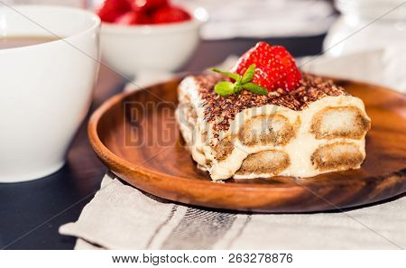 Tiramisu - Classical Dessert Garnished With Strawberry And Mint