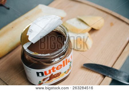 Moscow, Russia - Jctjber 10, 2018: Jar Of Nutella Hazelnut Sliced Baguette And Table Knife On A Wood