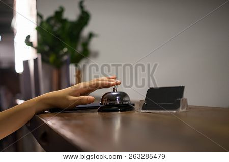 Close Up Women Call Hotel Reception On Counter Desk With Finger Push A Bell In Lobby Hotel. Hotel Co