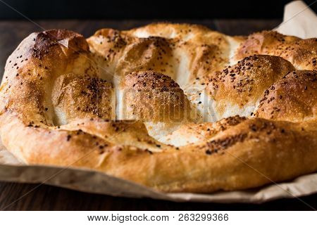 Turkish Ramadan Bread - Ramazan Pidesi On Wooden Surface / Pide