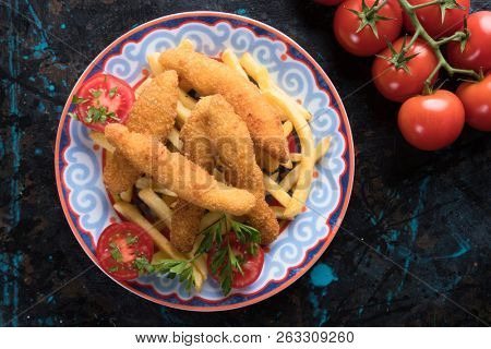 Deep fried chicken frites with potato chips or french fries