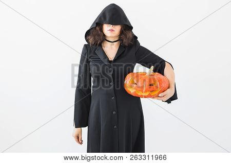Halloween And Holidays Concept - Witch Woman With Jack Olantern Pumpkin